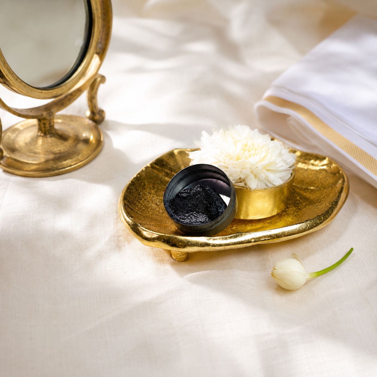 Aragaja Mai sacred kajal with a brass mirror and jasmine bud for daily drishti protection